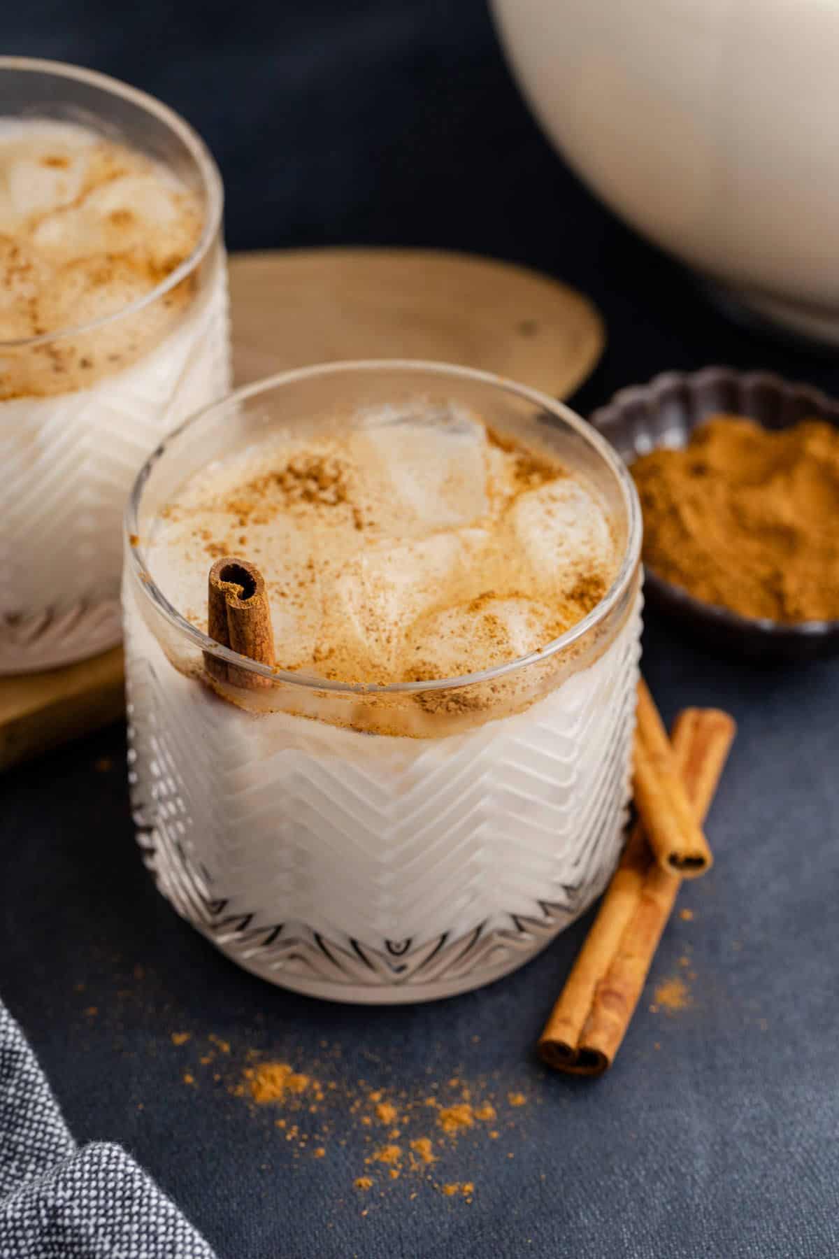 Agua horchata in two glasses with cinnamon garnish,