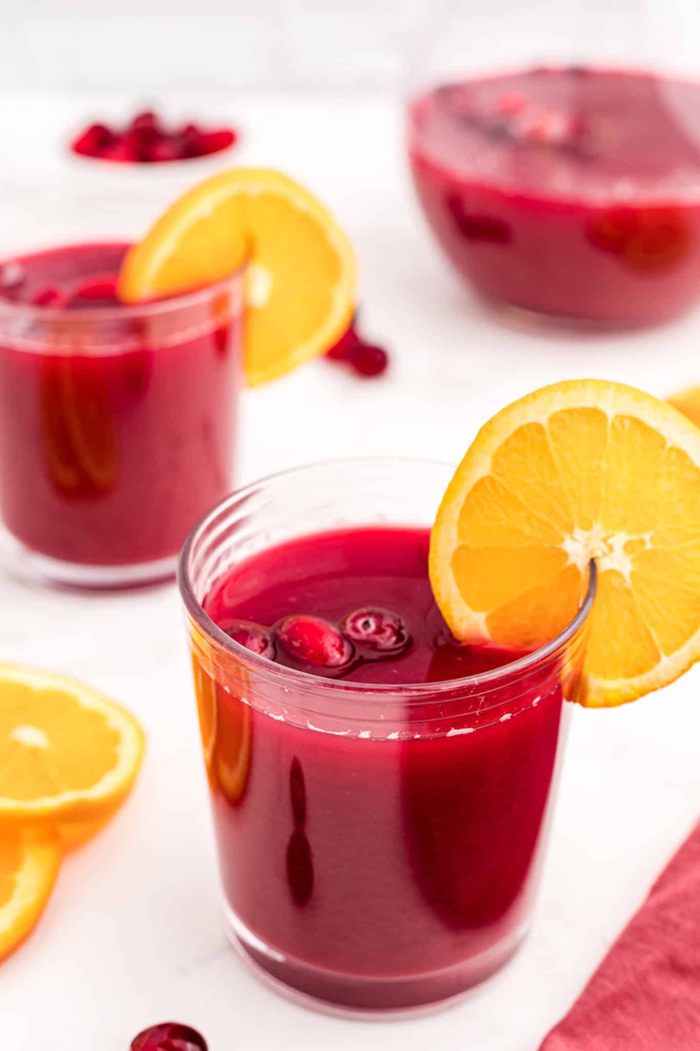 Christmas morning punch in 3 glasses with orange slices for garnish,