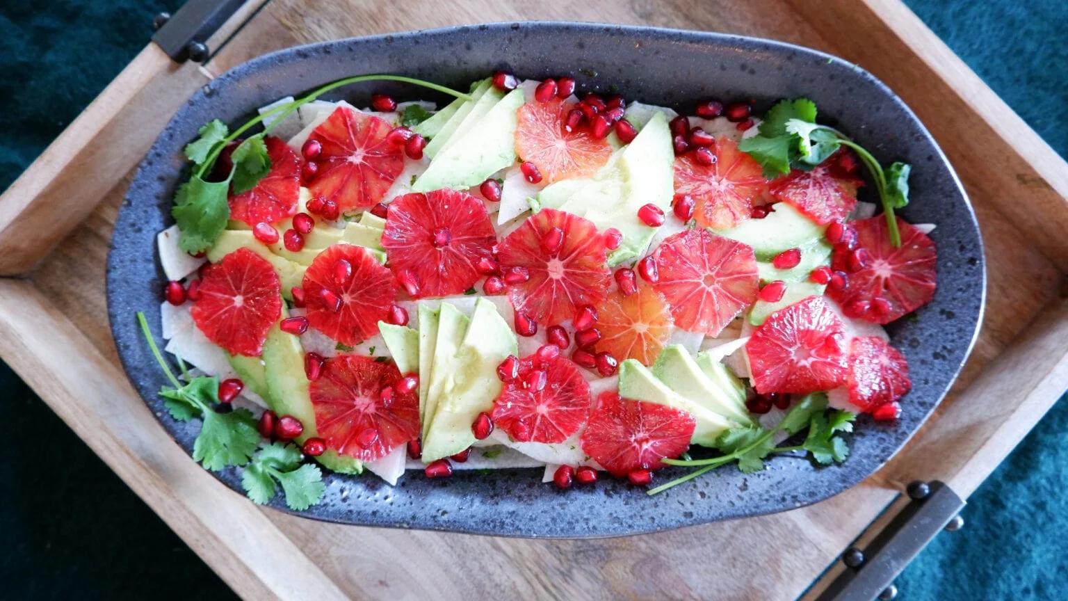 Jicama blood orange salad in a large metal serving vessel.