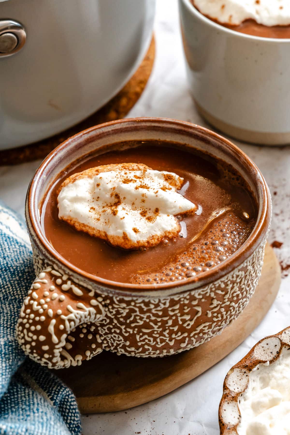 Gingerbread hot chocolate in a short brown mug with raised white dot details.