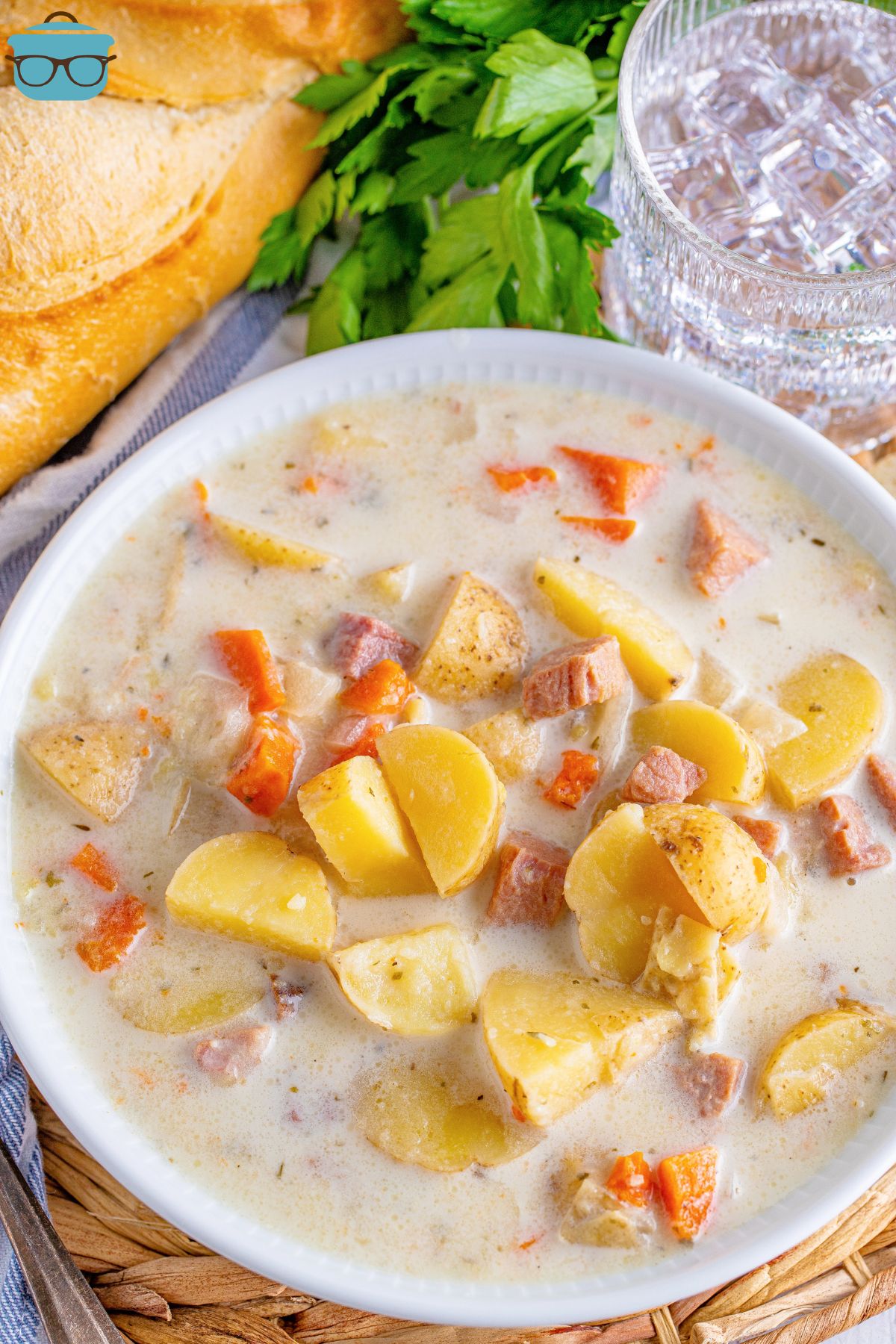 Ham, potato, and carrot soup in a white bowl.