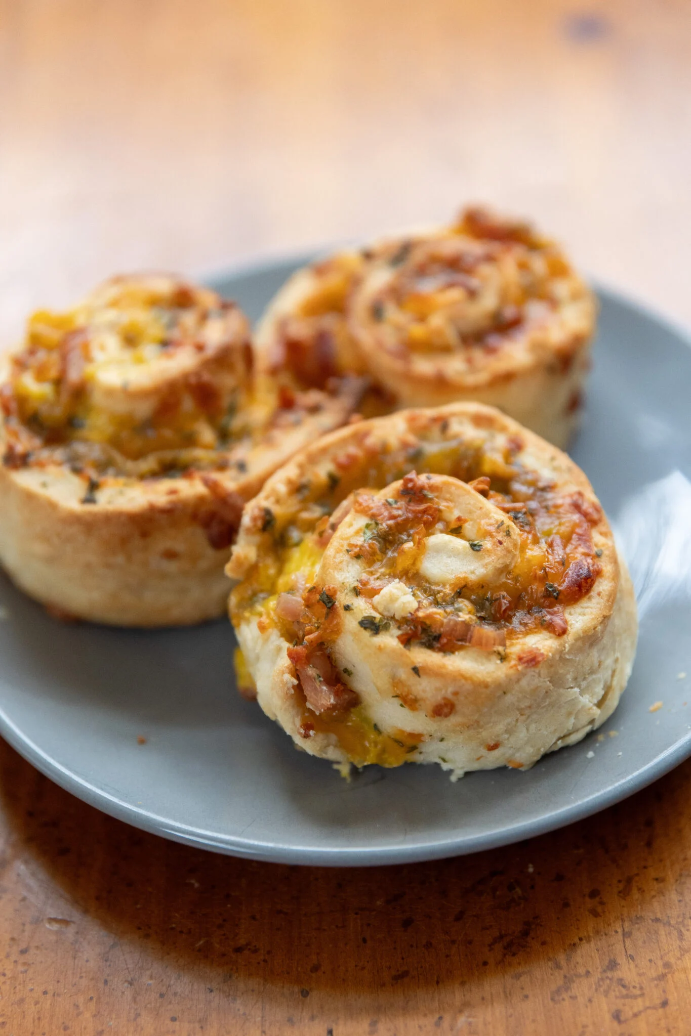 Ham and cheese biscuit roll-ups on a light blue plate.