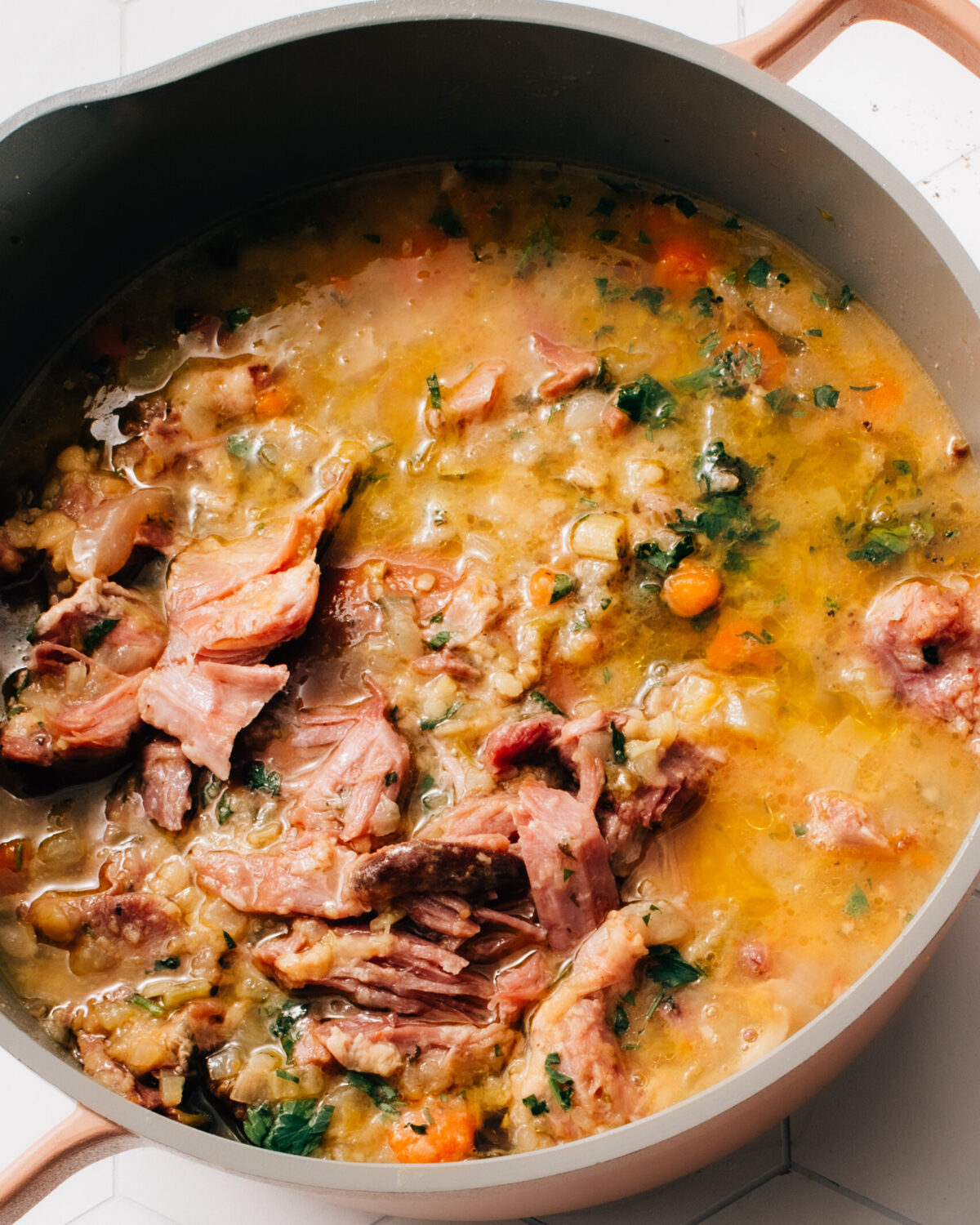 Ham and lentil stew in a large stock pot with lots of veggies.
