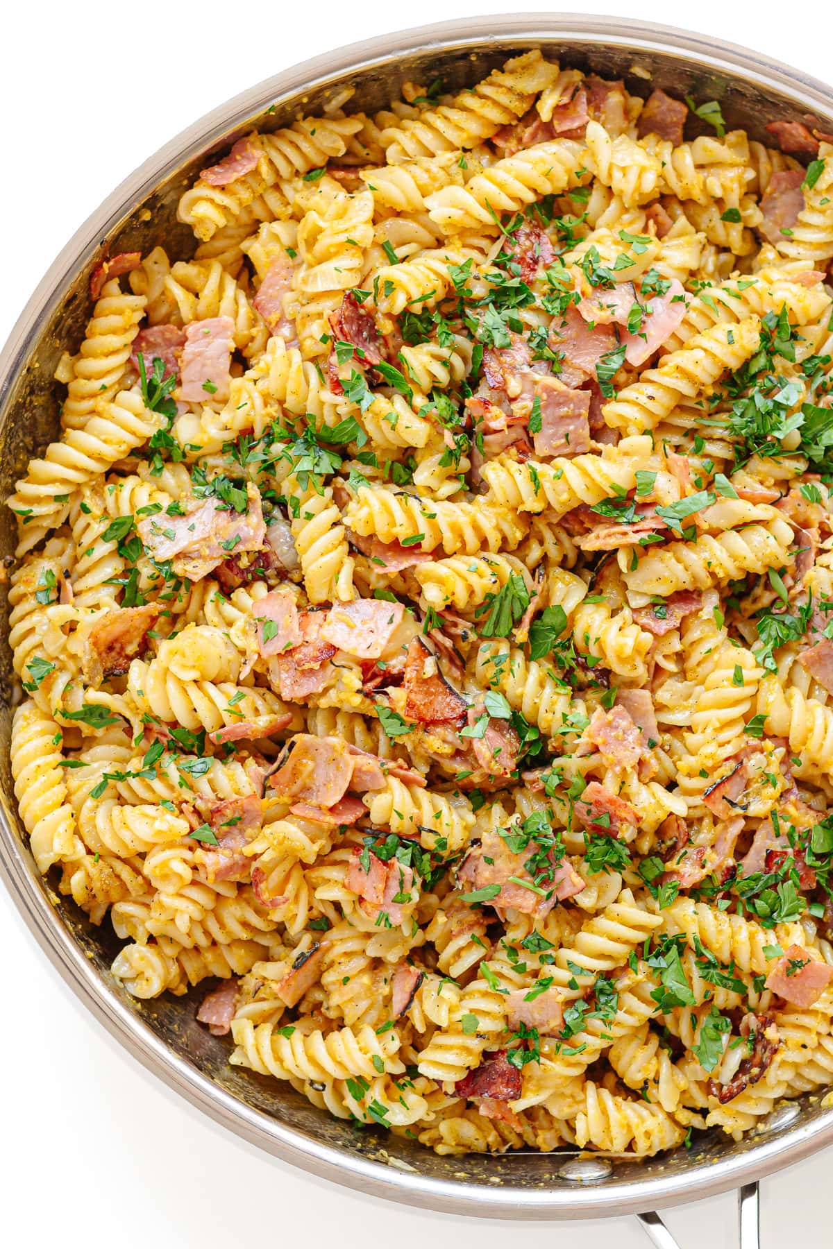 German ham and egg pasta in a large metal serving bowl.