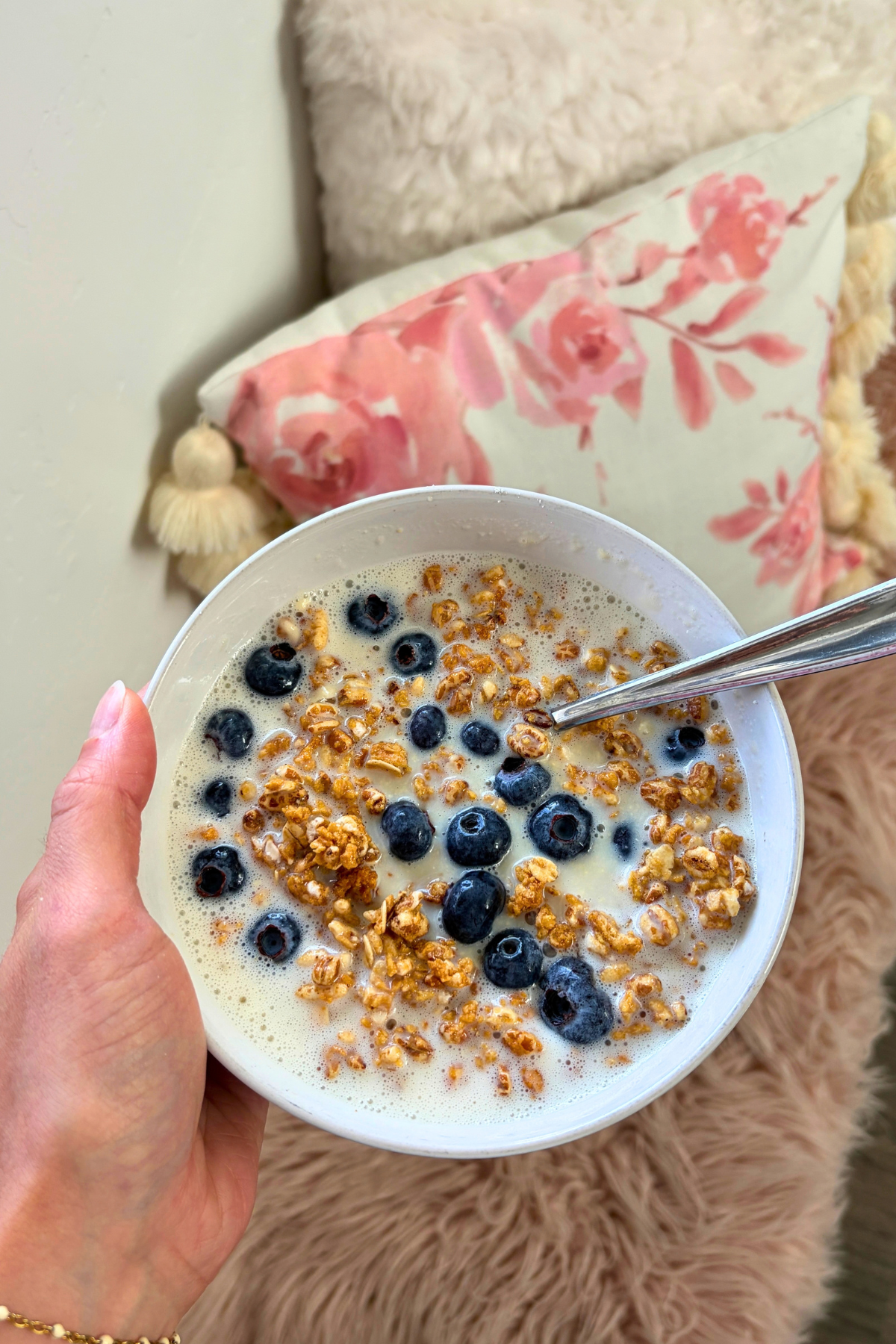 Protein cereal bowl with fresh blueberries and fiber cereal in frothed vanilla protein milk.